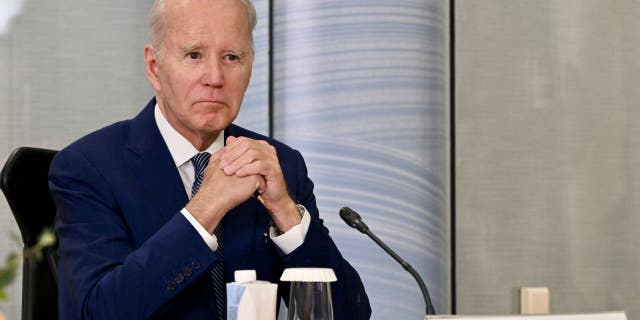 Biden folding hands at G-7