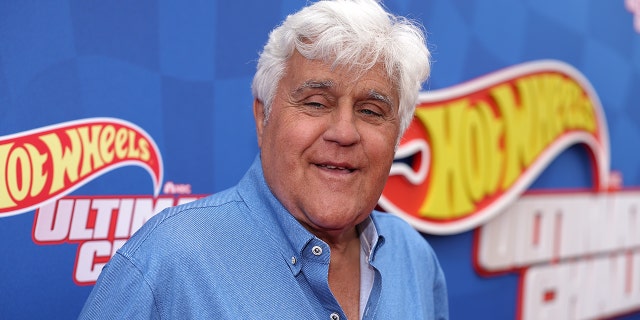 Jay Leno in a jean shirt smiles in El Segundo, CA at a HOT WHEELS event