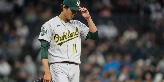 A's pitcher Shintaro Fujinami walks off the mound