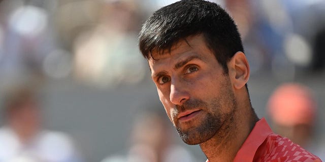 Novak Djokovic plays during the first round of the French Open