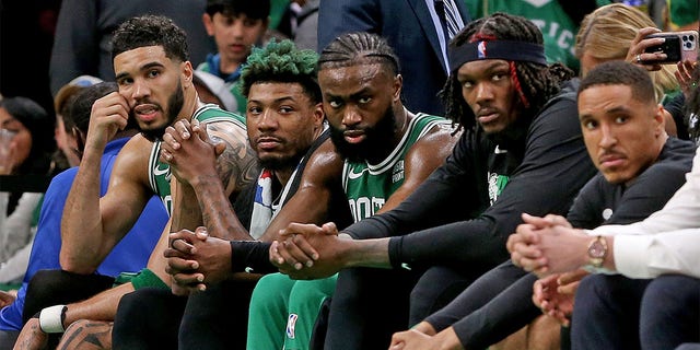 The Celtics sit on the bench during Game 7