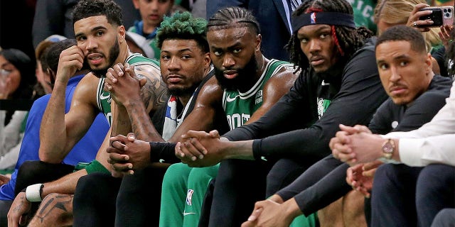 The Celtics sit on the bench during Game 7