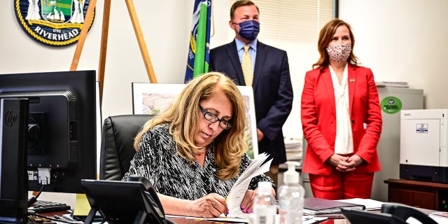 Another suburban New York community declares emergency as Adams to bus migrants from NYC to Long Island 3 Supervisor Yvette Aguiar at her desk