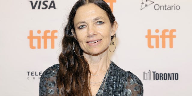 Justine Bateman soft smiles at the Toronto International Film Festival wearing large hoop earrings 