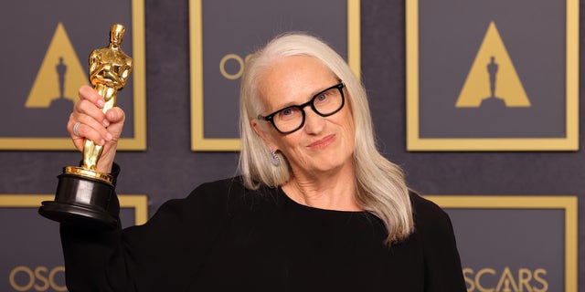 Jane Campion holds her Oscar.