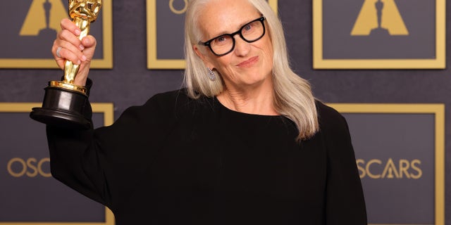 Jane Campion holds her Oscar.