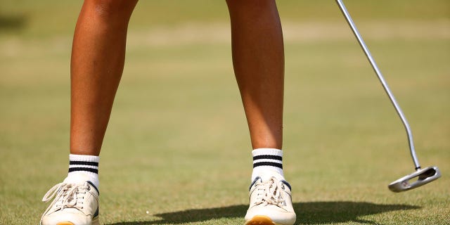 A golfer putts at the 2022 Division III Women's Golf Championship