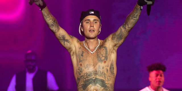 Justin Bieber performs onstage shirtless