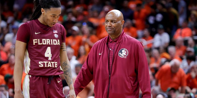 Caleb Mills talks with head coach Leonard Hamilton