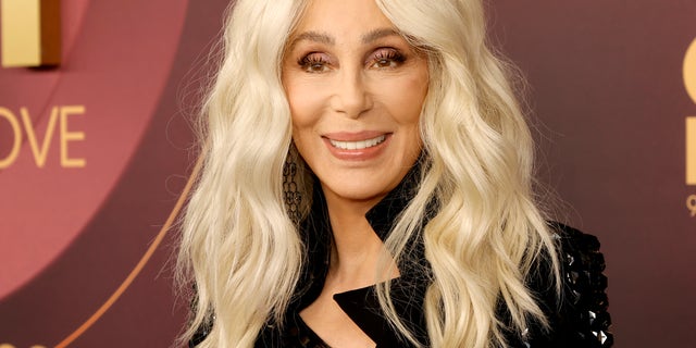 Cher with blonde hair smiling at camera