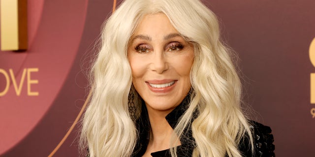 Cher with blonde hair smiling at camera