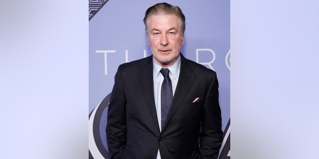 Alec Baldwin looks directly at the camera in a black suit while at The Roundabout Gala 2023 in New York City
