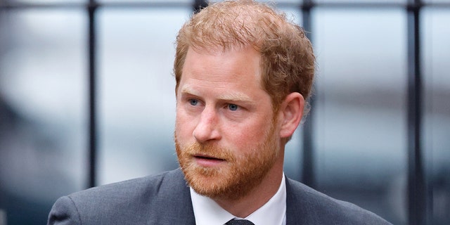 A close-up of Prince Harry in a grey suit