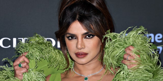 Priyanka Chopra reveals film director demanded to see her underwear, causing her to quit 2 Priyanka Chopra Jonas poses on the red carpet in a green gown with a green boa/feathers at the premiere of "Citadel"