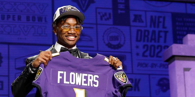 Zay Flowers poses after getting drafted by the Ravens