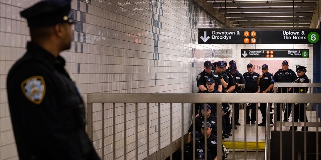 NYPD officers amid Jordan Neely vigil