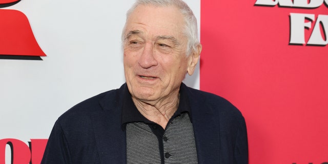 Robert De NIro looks off to his right and smiles while in New York City for the premiere of his film "About My Father"