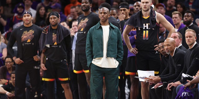 Chris Paul looks on from the bench