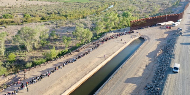 Immigrants seeking asylum in the U.S. wait after crossing into Arizona from Mexico on May 11, 2023.