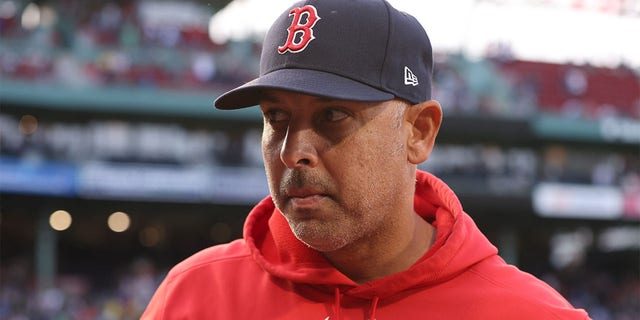 Alex Cora looks on before a game against Seattle