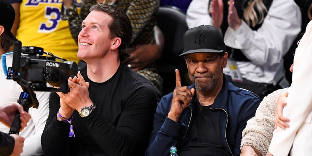 Denzel Washington doing the number one hand gesture at Lakers game