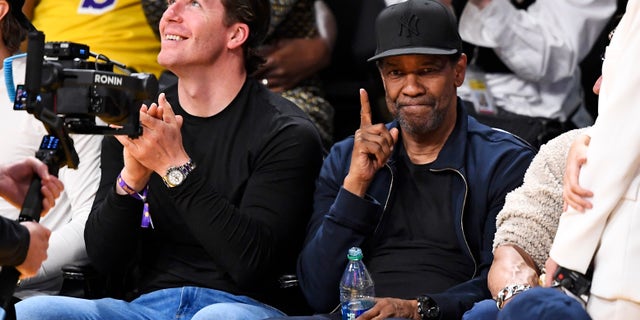 Denzel Washington doing the number one hand gesture at Lakers game