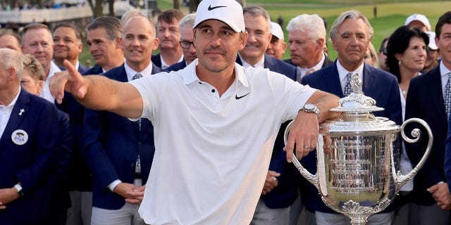 Brooks Koepka poses with the PGA Championship trophy