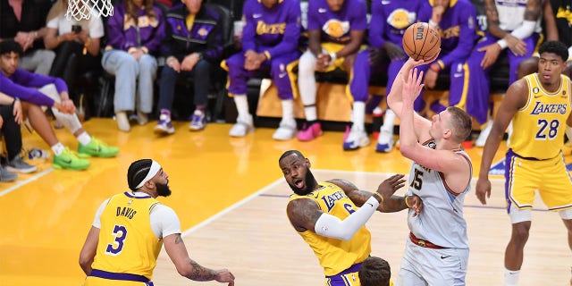 LeBron James commits an offensive foul