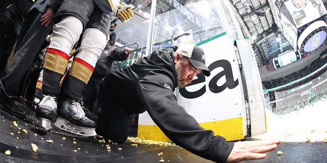 A Las Vegas staff member tries to clean up the popcorn