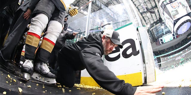 A Las Vegas staff member tries to clean up the popcorn