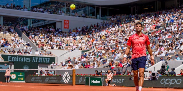 Novak Djokovic plays during the first round of the French Open