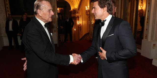 prince philip shaking hands with tom cruise