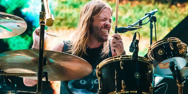 With his eyes closed Taylor Hawkins passionately plays the drums on stage