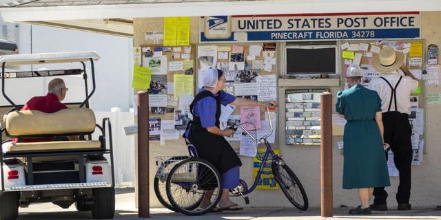 Members of the Amish stand outside a Florida post office.
