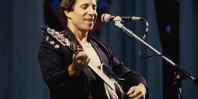 Paul Simon performing onstage in 1980