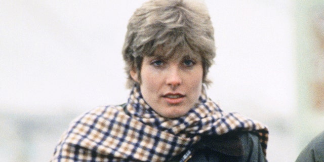 Anna Wallace in a plaid scarf and dark green jacket