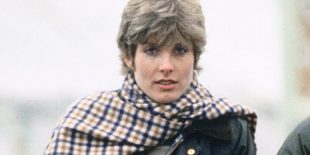 Anna Wallace in a plaid scarf and dark green jacket