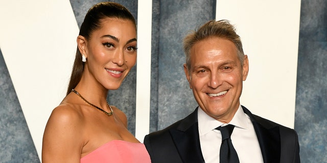 Sarah Staudinger in a pink strapless dress and Ari Emanuel in a suit and tie