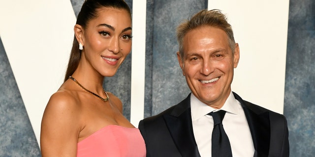 Sarah Staudinger in a pink strapless dress and Ari Emanuel in a suit and tie