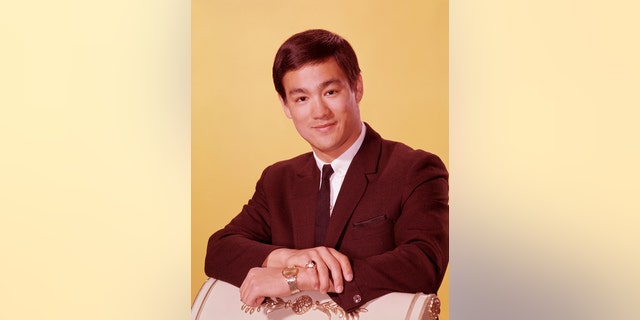 Bruce Lee in a suit with a skinny tie
