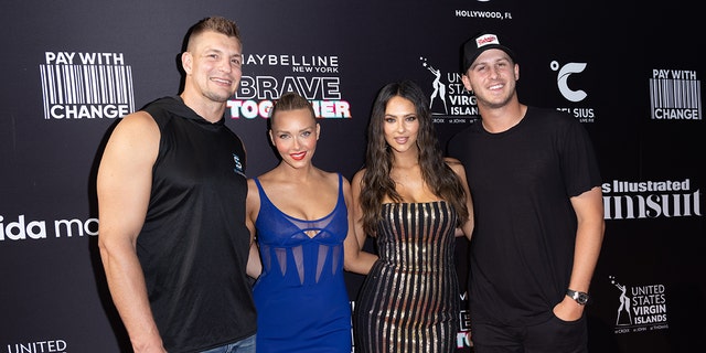 Rob Gronkowski, Camille Kostek, Jared Goff and Christen Harper posing together for a step and repeat photo