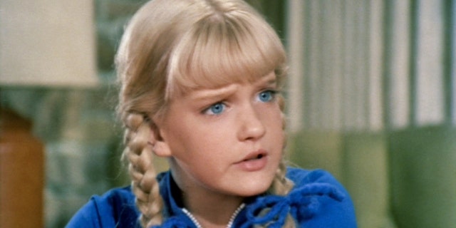 A close-up of Susan Olsen as Cindy Brady wearing a blue shirt