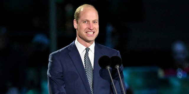 Prince William smiling on stage