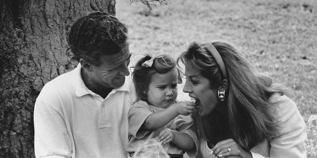 Denise Austin getting fed by her daughter in a black and white photo