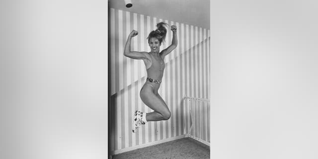 Denise Austin jumping a posing mid-air