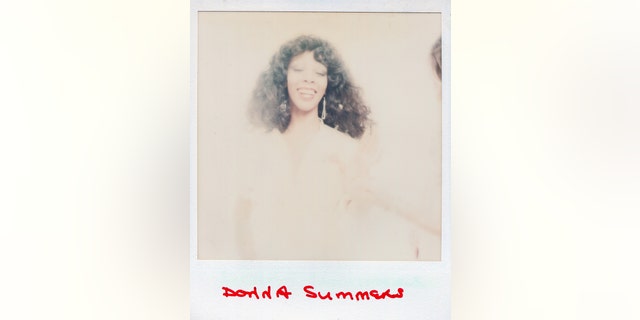 A polaroid of Donna Summer smiling in a hazy background