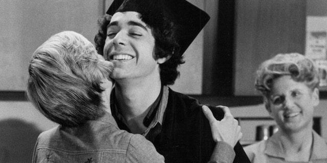 Barry Williams being embraced by Florence Henderson