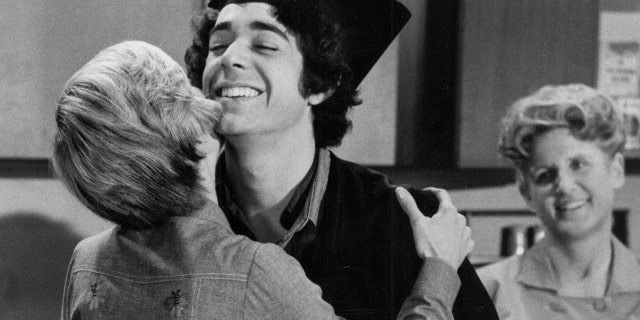 Barry Williams being embraced by Florence Henderson