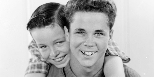 Jerry Mathers embracing Tony Dow in a close-up photo