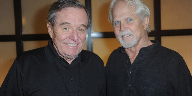 Jerry Mathers and Tony Dow both wearing black and smiling next to each other